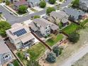 Aerial view showing a home with a well-maintained backyard, complete with a playset and solar panels at 10553 Joplin St, Commerce City, CO 80022