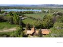 Wide aerial view of property with a lake in the background at 12855 N 66Th St, Longmont, CO 80503