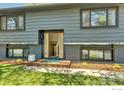 Inviting home entrance featuring a stylish front door and well-kept lawn at 1407 S Terry St, Longmont, CO 80501