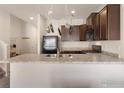 Well-equipped kitchen with stainless appliances, dark cabinetry, and sleek countertops at 1456 Sepia Ave, Longmont, CO 80501