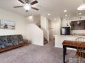 Inviting living room featuring neutral walls, carpeted floors, and a ceiling fan at 1456 Sepia Ave, Longmont, CO 80501