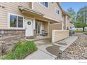 Townhouse entrance featuring a cozy patio with furniture and a lovely wreath on the door at 1601 Great Western Dr # D3, Longmont, CO 80501