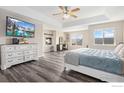 Relaxing bedroom with a large window, a fireplace, and modern decor at 1705 Wales Dr, Berthoud, CO 80513