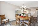 Bright dining room with stylish chandelier and dining table at 1705 Wales Dr, Berthoud, CO 80513
