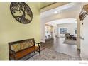 Welcoming entryway with hardwood floors and decorative wall art at 1705 Wales Dr, Berthoud, CO 80513