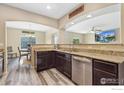 Open kitchen with granite countertops and stainless steel appliances at 1705 Wales Dr, Berthoud, CO 80513