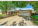 Charming home with mature trees shading the driveway and a spacious two-car garage at 1800 Atwood St, Longmont, CO 80501