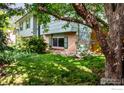 View of the private backyard with mature trees and well maintained landscaping at 1805 Del Rosa Ct, Boulder, CO 80304