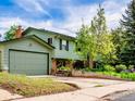 Exterior of the home shows the well manicured lawn, solar panels on roof and oversized two car garage at 1805 Del Rosa Ct, Boulder, CO 80304
