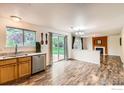Light dining area and partial kitchen view with access to outdoor patio through glass sliding doors at 1842 Reliance Cir, Superior, CO 80027