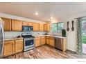 Well-lit kitchen features stainless steel appliances, wood cabinets, and marble countertops at 1842 Reliance Cir, Superior, CO 80027