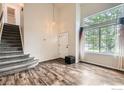 Open living room with hardwood floors, large windows, and staircase to the upper level at 1842 Reliance Cir, Superior, CO 80027
