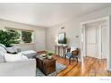 Bright living room featuring hardwood floors, a comfortable gray sectional sofa, and lots of natural light at 2022 Ford St, Golden, CO 80401