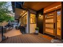 Inviting porch with a wooden ceiling, outdoor seating, and a contemporary front door with glass panels at 2725 6Th St, Boulder, CO 80304