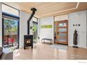 Bright living room featuring a modern fireplace, light wood floors, and large windows with a view at 2725 6Th St, Boulder, CO 80304