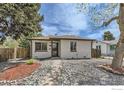 Inviting home featuring a well-maintained front yard with decorative stones and a brick pathway leading to the entrance at 3204 S Cherokee St, Englewood, CO 80110