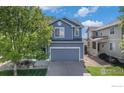 Charming two-story home with a well-maintained front yard, and a two car garage at 4005 Frederick Cir, Longmont, CO 80503