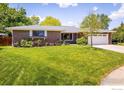 Single-story brick home with a manicured lawn, mature trees, and an attached garage at 4760 Lee Cir, Boulder, CO 80303