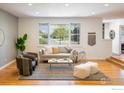 Bright living room with hardwood floors, large windows, and stylish contemporary furnishings at 4760 Lee Cir, Boulder, CO 80303