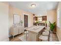 Dining area features modern chairs, a wooden table, and lots of natural light at 6058 S Hill St, Littleton, CO 80120
