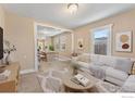 Inviting living room featuring a comfortable seating arrangement, open to the dining area at 6058 S Hill St, Littleton, CO 80120