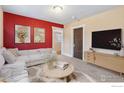 Bright living room with a modern sofa, stylish decor, and ample natural light at 6058 S Hill St, Littleton, CO 80120