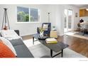 Open living room with natural light, hardwood floors, and modern decor at 713 Arrow Ct, Lafayette, CO 80026