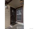 Secure, covered entrance includes a sturdy metal security door and bright sidelight window at 7820 W 87Th Dr # K, Arvada, CO 80005