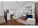 Inviting living room with vaulted ceilings, cozy seating, and hardwood floors at 810 Trail Ridge Dr, Louisville, CO 80027