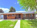 Charming home with a well-maintained front yard, covered porch, and beautiful landscaping at 815 S Jersey St, Denver, CO 80224