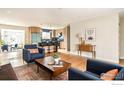 Open floor plan showcasing the modern kitchen and bright living room with hardwood floors and stylish furnishings at 815 S Jersey St, Denver, CO 80224