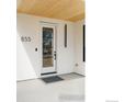 Welcoming entryway featuring a glass front door, modern address numbers, and minimalist exterior lighting at 855 Eudora St, Denver, CO 80220