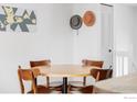 Cozy dining area with a round table and mid-century modern chairs, creating a welcoming space for meals at 1013 Alsace Way, Lafayette, CO 80026