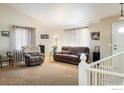 Inviting living room with neutral tones, comfortable seating, and ample natural light at 1030 S Fulton Ave, Fort Lupton, CO 80621