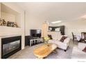 Comfortable living room with a fireplace and open concept layout at 1148 Opal St # 101, Broomfield, CO 80020
