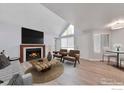 Bright living room with vaulted ceiling, modern furniture, wood floors and fireplace at 12525 E Tennessee Cir # E, Aurora, CO 80012