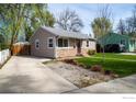 A single-story home with a driveway and well-kept front lawn at 128 E 5Th Ave, Longmont, CO 80504
