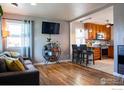 Open living space with hardwood floors flowing into the updated kitchen at 128 E 5Th Ave, Longmont, CO 80504