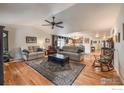 Spacious living room featuring hardwood floors and large area rug at 13642 Wrangler Way, Mead, CO 80542