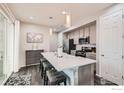 Modern kitchen with a spacious island, stainless steel appliances, and pendant lighting at 17106 E Alameda Pkwy, Aurora, CO 80017