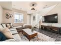 Inviting living room featuring wood floors, a large window and stylish furnishings at 17106 E Alameda Pkwy, Aurora, CO 80017
