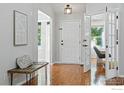 Bright foyer featuring hardwood floors, a bench, and elegant french doors leading to another room at 1970 Hamron Ct, Erie, CO 80516