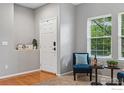 Light-filled entryway featuring hardwood floors and views of the outdoors at 200 Mcafee Cir, Erie, CO 80516