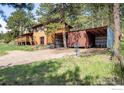 Exterior view of a home with a covered carport, offering sheltered parking and storage space at 201 Wild Tiger Rd, Boulder, CO 80302