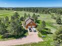 Aerial view of a two-story home with an attached two-car garage and a long, winding driveway at 2219 Meadow Green Cir, Franktown, CO 80116