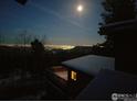 Nighttime view from the home showcasing the city lights below and the moon above at 25808 Sunrise Ln, Golden, CO 80401