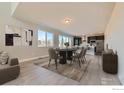 Open dining room with a modern table and chairs, connecting to the kitchen and living areas at 2710 Crystal Springs, Longmont, CO 80503