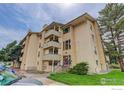 Multi-story apartment building featuring balconies, tan brick exterior, and well-maintained landscaping at 3030 Oneal Pkwy # 10, Boulder, CO 80301
