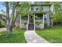 Inviting home exterior featuring a covered porch, lush lawn, and stone walkway at 3219 7Th St, Boulder, CO 80304