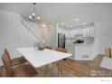 Inviting dining area featuring table setting beside open kitchen at 3648 Oakwood Dr, Longmont, CO 80503